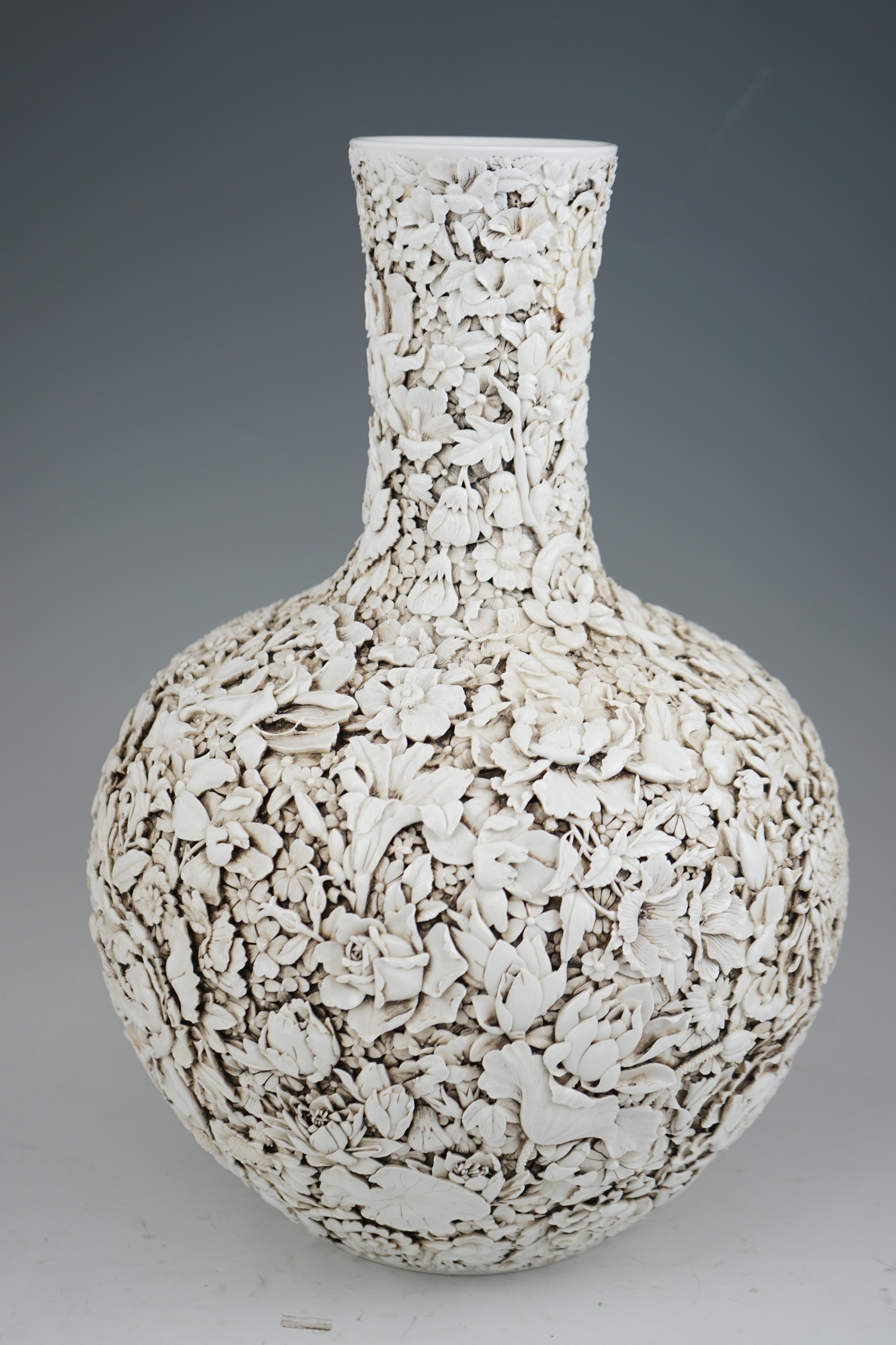 A large Chinese carved porcelain ‘thousand flower’ bottle vase, 20th century